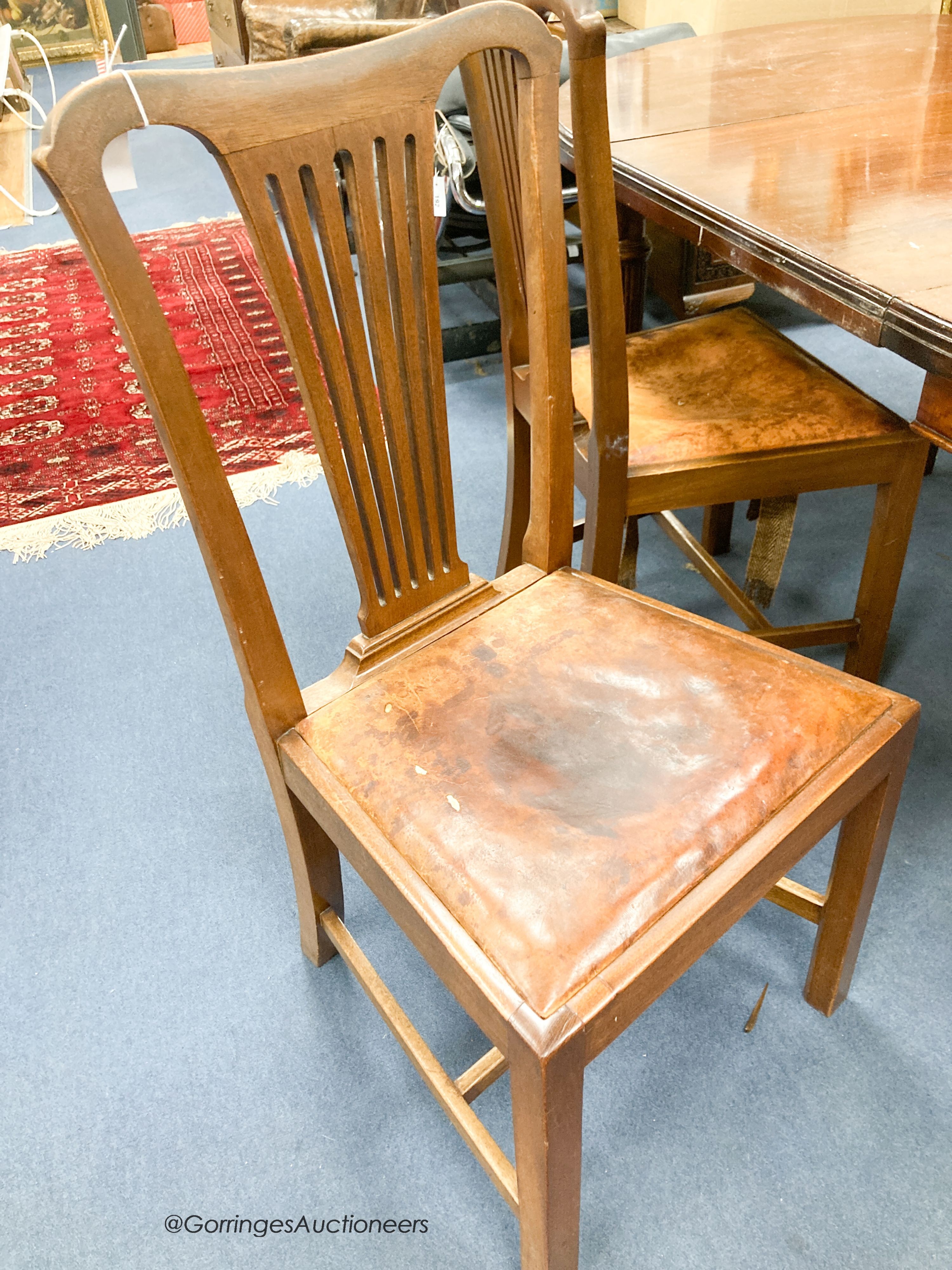 An Edwardian mahogany oval extending dining table, length 180cm extended with one spare leaf, width 120cm, height 74cm together with four George III style mahogany dining chairs